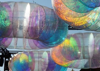 La instalación de óculo flotante brilla con una luz cromática cambiante